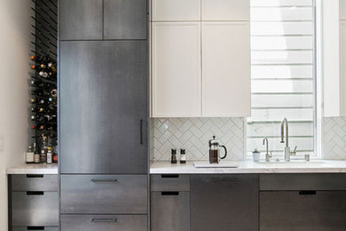 Large minimalist l-shaped light wood floor enclosed kitchen photo in San Francisco with an undermount sink, recessed-panel cabinets, stainless steel cabinets, white backsplash, ceramic backsplash, stainless steel appliances, no island and quartzite countertops