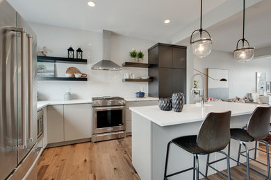 Inspiration for an eclectic kitchen in Calgary with flat-panel cabinets, black cabinets and quartzite benchtops.
