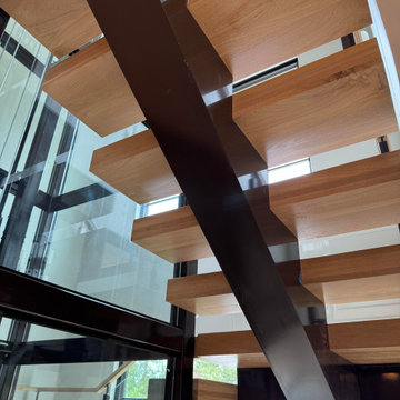 Project #136 | Modern Floating Staircase Encircling Glass Elevator