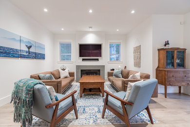 Mid-sized transitional open concept laminate floor and beige floor family room photo in Vancouver with white walls, a standard fireplace, a concrete fireplace and a wall-mounted tv