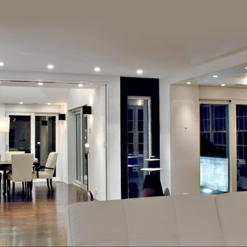 Open-concept living room complete with automated lighting and shade controls