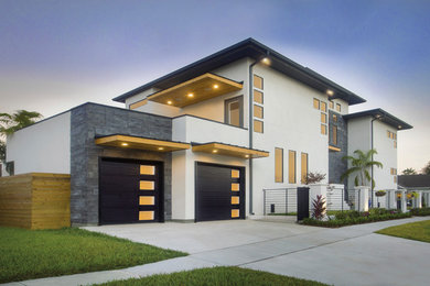 Photo of a large modern two-storey concrete white house exterior in Tampa with a flat roof.