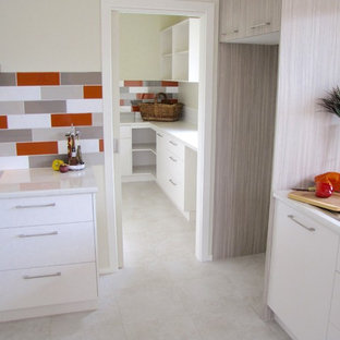 Mid-sized contemporary kitchen pantry designs - Inspiration for a mid-sized contemporary l-shaped ceramic floor kitchen pantry remodel in Melbourne with a double-bowl sink, shaker cabinets, white cabinets, laminate countertops, multicolored backsplash, ceramic backsplash, stainless steel appliances and an island