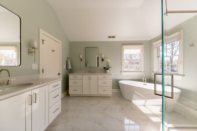 Bathroom - large transitional master white tile and porcelain tile porcelain tile, white floor and double-sink bathroom idea in Chicago with recessed-panel cabinets, white cabinets, a two-piece toilet, green walls, an undermount sink, quartz countertops, a hinged shower door and white countertops
