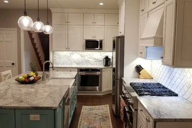 Large transitional galley medium tone wood floor and brown floor eat-in kitchen photo in Other with a farmhouse sink, recessed-panel cabinets, white cabinets, quartzite countertops, white backsplash, ceramic backsplash, stainless steel appliances, an island and multicolored countertops