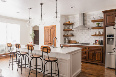 Example of a large transitional galley brown floor eat-in kitchen design in Oklahoma City with a farmhouse sink and an island
