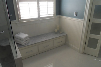 Inspiration for a large transitional master white tile and porcelain tile porcelain tile bathroom remodel in Raleigh with furniture-like cabinets, granite countertops and blue walls