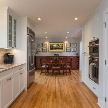 Modern Kitchen with White Flat Panel Shaker Cabinets & Natural Stone Backsplash