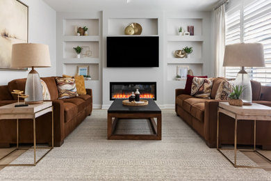 Inspiration for a mid-sized contemporary open concept laminate floor and brown floor living room remodel in Raleigh with gray walls, a standard fireplace and a wall-mounted tv