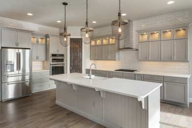 Mid-sized trendy eat-in kitchen photo in Raleigh with recessed-panel cabinets, gray cabinets, white backsplash, an island and white countertops