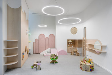 Inspiration for a mid-sized modern gender-neutral carpeted and gray floor playroom remodel in New York with white walls