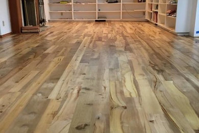 Example of a large transitional medium tone wood floor and brown floor living room design in Portland