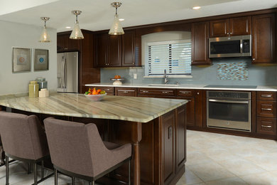 Eat-in kitchen - large coastal l-shaped white floor eat-in kitchen idea in Orlando with an undermount sink, raised-panel cabinets, dark wood cabinets, stainless steel appliances and a peninsula