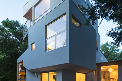 Inspiration for a contemporary white three-story stucco exterior home remodel in Austin