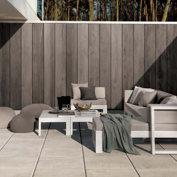 Contemporary patio with grey stone look porcelain tile floors