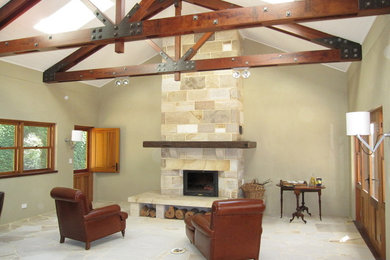 Country family room in Sydney with a stone fireplace surround.