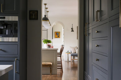 Example of a small tuscan u-shaped terra-cotta tile kitchen pantry design in Los Angeles with an undermount sink, shaker cabinets, black cabinets, quartz countertops and gray countertops