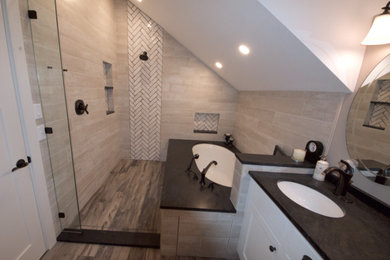 Doorless shower - cottage porcelain tile doorless shower idea in Other with flat-panel cabinets, white cabinets, an undermount tub, granite countertops and black countertops
