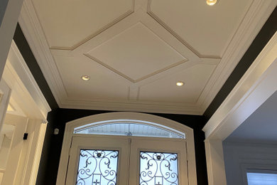 Photo of a traditional entrance in Toronto with a coffered ceiling.