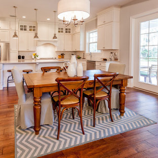 Mid-sized transitional medium tone wood floor and brown floor kitchen/dining room combo photo in Jacksonville with gray walls and no fireplace