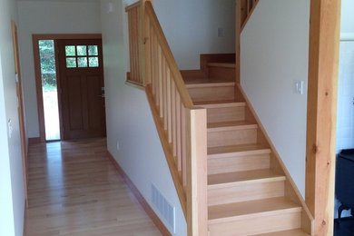Inspiration for a mid-sized farmhouse wooden l-shaped staircase remodel in Vancouver with wooden risers