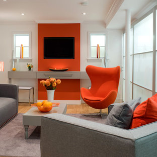 Photo of a contemporary basement in Toronto with orange walls and medium hardwood flooring.