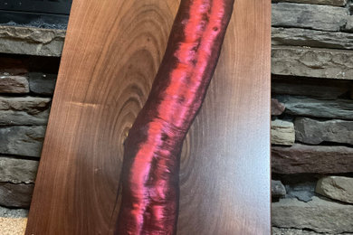 Walnut charcuterie board with red epoxy river