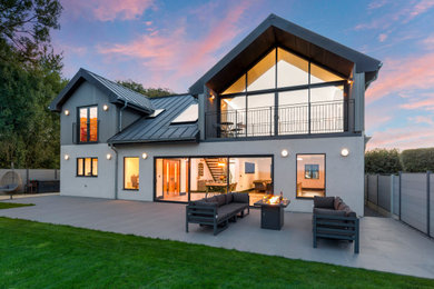 Large contemporary two floor detached house in Wiltshire with a hip roof, a metal roof and a grey roof.