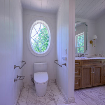 Primary Bathroom with Double Shower and Natural Stone Baseboards
