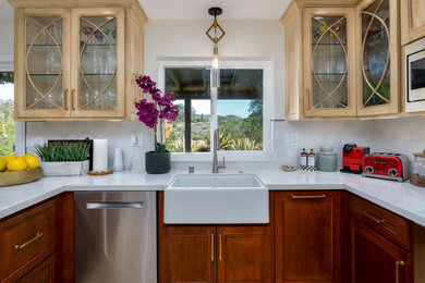 Eat-in kitchen - mid-sized transitional u-shaped ceramic tile, beige floor and tray ceiling eat-in kitchen idea in Hawaii with a farmhouse sink, recessed-panel cabinets, medium tone wood cabinets, quartz countertops, white backsplash, stainless steel appliances, a peninsula and white countertops