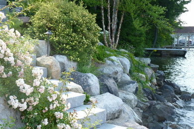 This is an example of a mid-sized contemporary full sun backyard concrete paver landscaping in Boston for fall.