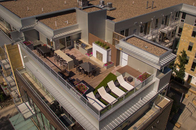Minimalist patio kitchen photo in Minneapolis with a roof extension