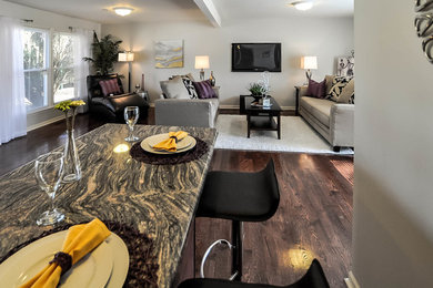 Example of a mid-sized transitional open concept dark wood floor family room design in Chicago with gray walls, no fireplace and a wall-mounted tv