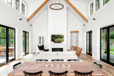 Beach style open concept light wood floor family room photo in Other with gray walls, a tile fireplace and a wall-mounted tv