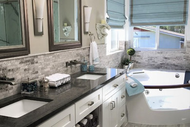 Arts and crafts master gray tile and mosaic tile ceramic tile and gray floor bathroom photo in Seattle with shaker cabinets, white cabinets, a one-piece toilet, gray walls, an undermount sink, quartz countertops and a hinged shower door