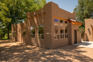 Mid-sized southwest brown two-story stucco exterior home photo in Other