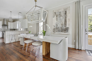 Example of a large transitional open concept medium tone wood floor and brown floor living room design in New Orleans with gray walls