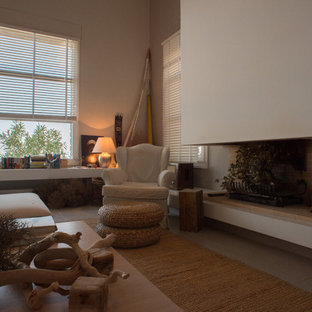 Mediterranean mezzanine living room in Other with a hanging fireplace, a plastered fireplace surround, grey walls and ceramic flooring.
