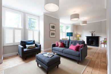 This is an example of a mid-sized eclectic living room in Oxfordshire with a metal fireplace surround.
