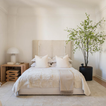 Primary Bedroom with Upholstered Headboard and Indoor Tree in Lisbon