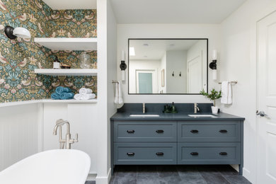 Inspiration for a mid-sized transitional master porcelain tile, black floor, double-sink and wallpaper bathroom remodel in Vancouver with shaker cabinets, blue cabinets, a two-piece toilet, white walls, an undermount sink, quartz countertops, gray countertops and a built-in vanity
