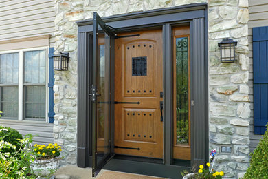 This is an example of a midcentury front door in Other with a single front door and a medium wood front door.