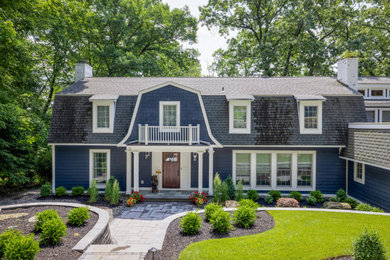 Large and blue bohemian two floor detached house in New York with wood cladding, a mansard roof, a tiled roof, a grey roof and shiplap cladding.