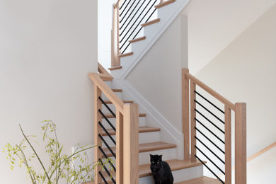 Large country wooden u-shaped mixed material railing staircase photo in DC Metro with painted risers