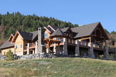 Huge traditional beige three-story mixed siding exterior home idea in Other with a shingle roof