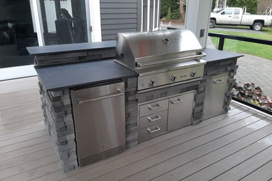 Example of an arts and crafts backyard patio kitchen design in Seattle