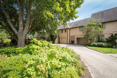 Example of a large beige exterior home design in Philadelphia