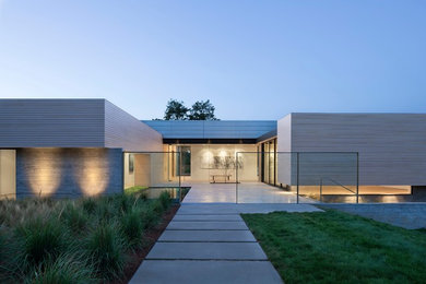 Large minimalist white one-story wood flat roof photo in San Francisco