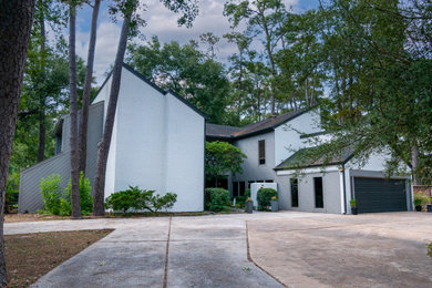 Example of a huge trendy gray two-story concrete fiberboard and clapboard exterior home design in Houston with a shingle roof and a black roof