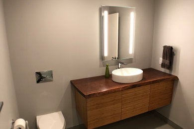 Bathroom remodel with custom Walnut countertop, wall hung toilet, and more.